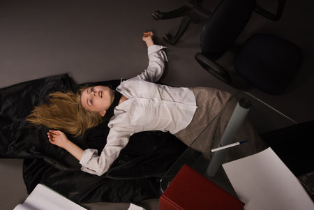 Srangled college girl lying on the floorの写真素材