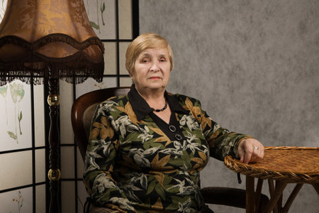 Portrait of a lovely old woman in a vintage style interior