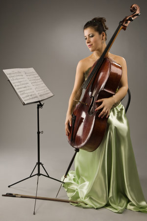 Attractive woman in evening dress with celloの写真素材