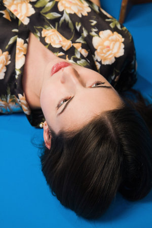 Lifeless brunette in a dressing gown lying on the floorの写真素材