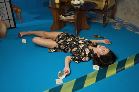 Lifeless brunette in a dressing gown lying on the floorの写真素材