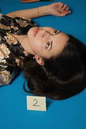 Lifeless brunette in a dressing gown lying on the floorの写真素材