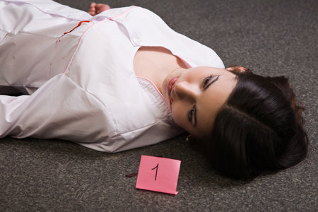 Crime scene. Dead nurse lying on the floorの写真素材