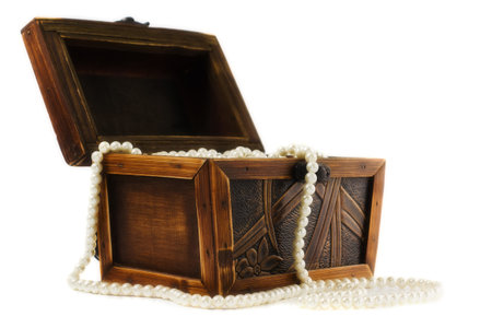 Wooden jewellery box packed with necklace and beadsの写真素材