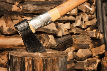 Axe in log on a firewoods background