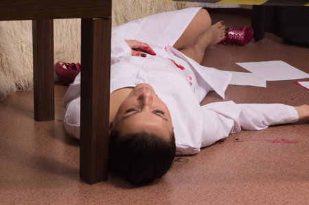 Crime scene simulation: dead nurse lying on the floorの写真素材