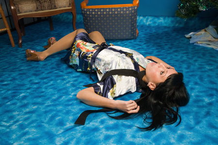 Crime scene simulation: strangled  brunette lying on the floorの写真素材