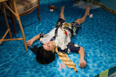 Crime scene simulation: strangled  brunette lying on the floorの写真素材