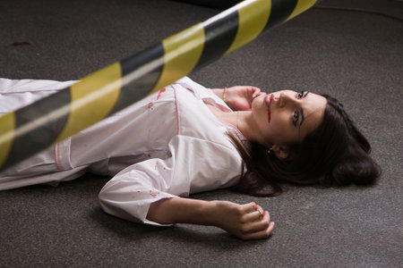 Crime scene imitation. Nurse lying on the floorの写真素材