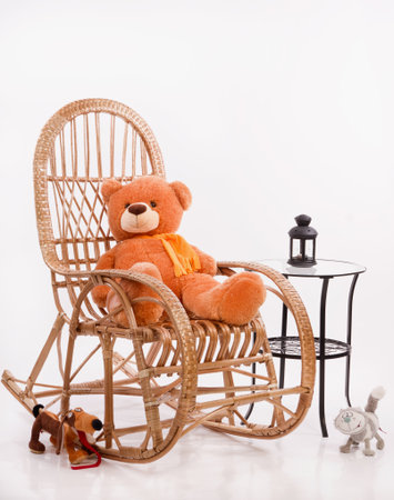 Old wooden rocking chair with toys over white backgroundの写真素材