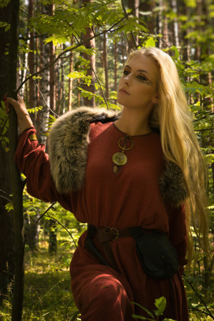 Scandinavian girl with runic signs on a forest backgroundの写真素材