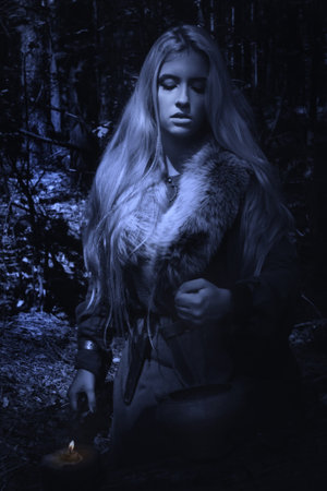 Scandinavian witch pythoness cooking potion in a dark forest