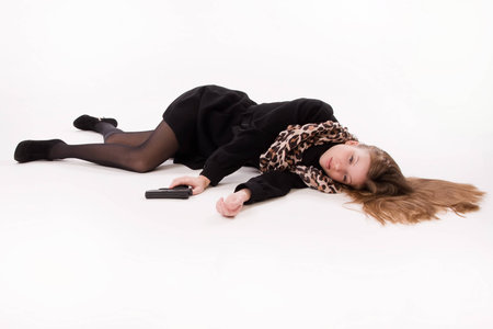 Crime scene imitation. Spy girl with gun lying on the floorの写真素材