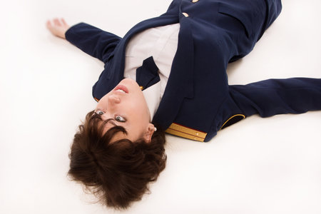 Crime scene imitation. Woman officer lying on a floorの写真素材