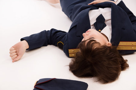 Crime scene imitation. Woman officer lying on a floorの写真素材