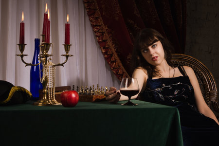 Fashionable women with red wine glass in a handの写真素材