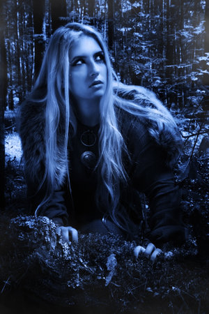 Scandinavian girl in the night dark forest
