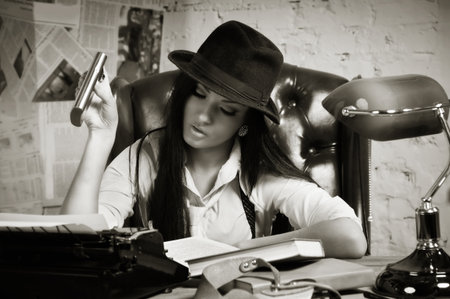 Retro detective girl in the detective agencyの写真素材