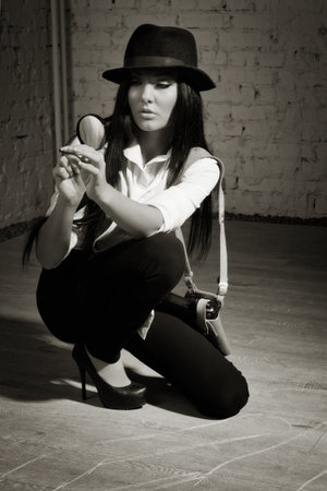 Retro detective sees the evidence in the magnifierの写真素材