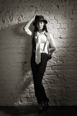 Retro detective girl on a wall background