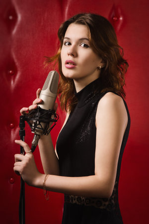 An elegant female singer with microphoneの写真素材