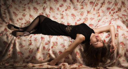 Attractive sensual brunette lying on the sofaの写真素材