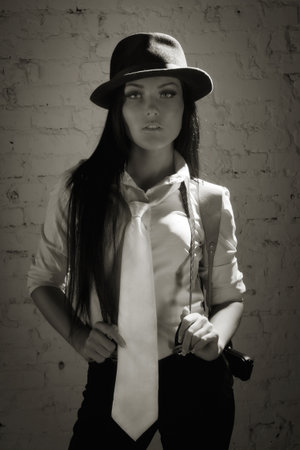 Retro detective girl on a wall backgroundの写真素材