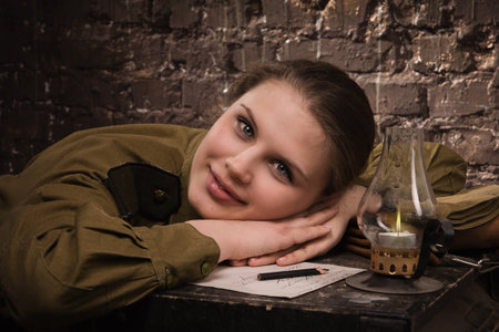 Soviet female soldier in uniform of World War II in the dugoutの写真素材