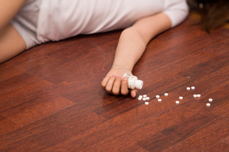 Crime scene simulation: overdosed victim lying on the floorの写真素材