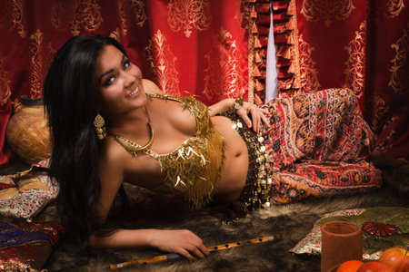 Beautiful belly dancer lying down