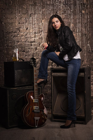 Sexy rock babe in leather jacket with cigaretteの写真素材