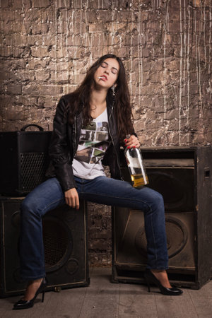 Sexy rock babe in leather jacket with cigaretteの写真素材