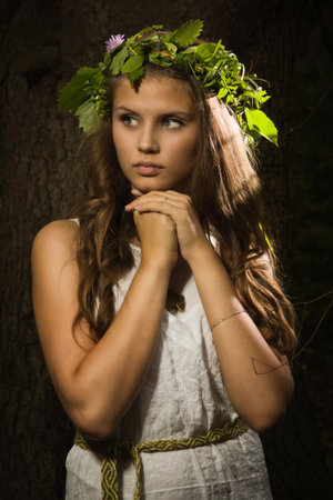 Slavonian girl in the traditional suit in the deep forestの写真素材