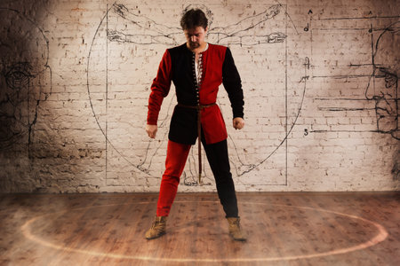 Man in medieval suit performing magic momentの写真素材