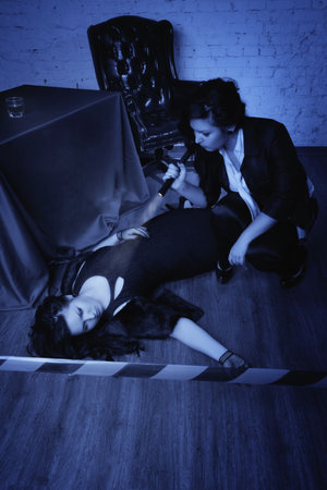 Retro girl detective  collecting evidence at a crime sceneの写真素材