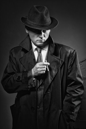 Film noir. Retro styled fashion portrait of a detectiveの写真素材