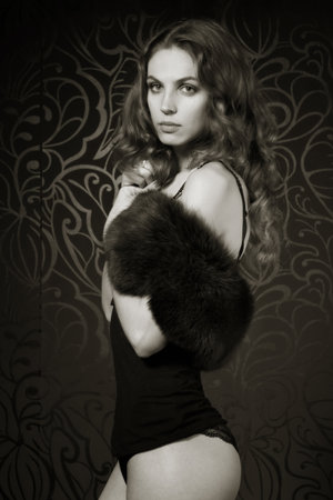 Pretty woman in the dark interiorの写真素材