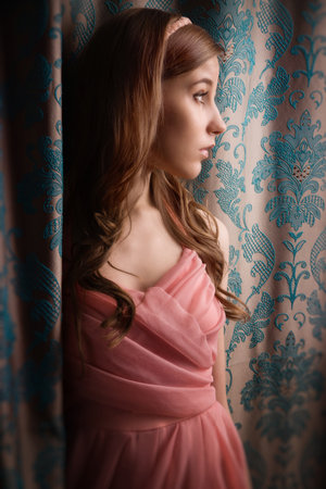 Portrait of the beautiful girl in the vintage interiorの写真素材