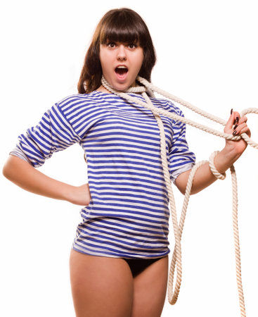 Beautiful woman sailor in pinup style strangles herself on white backgroundの写真素材