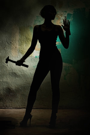 girl with a hammer in handの写真素材