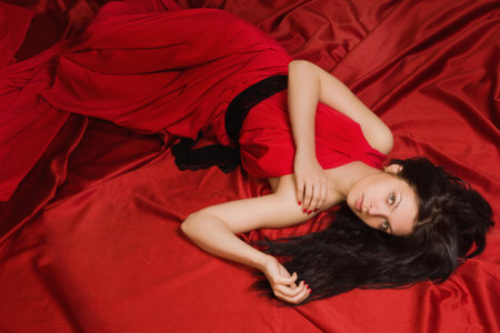 Fashionable lady in a red dress in the vintage interiorの写真素材