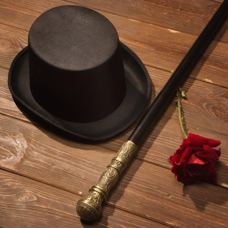 hat, cane and rose on a wooden floorの写真素材