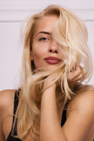 Hot blonde girl posing in white roomの写真素材