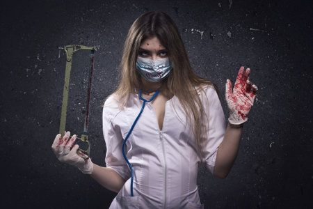 Crazy bloody nurse in a dark roomの写真素材