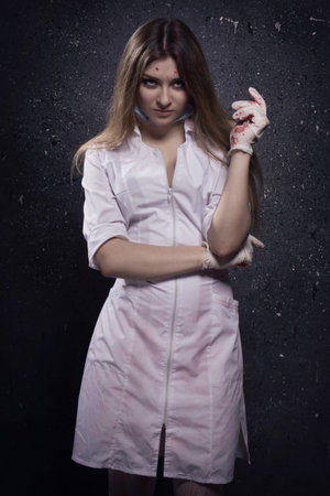 Crazy bloody nurse in a dark roomの写真素材