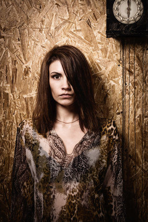 Asylum. Lonely mad woman in a dark room. Low key.の写真素材