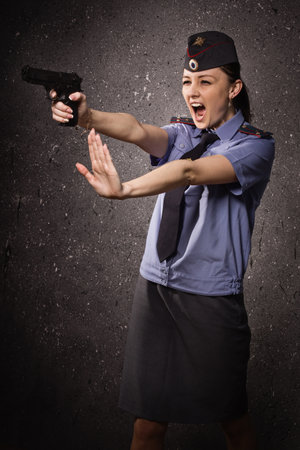 Russian woman police officer shooting with a pistolの写真素材