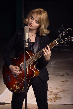 Rock star singing into a microphone on industrial backgroundの写真素材