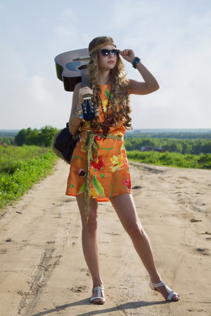 Romantic girl travelling with her guitar. Hippie style.の写真素材
