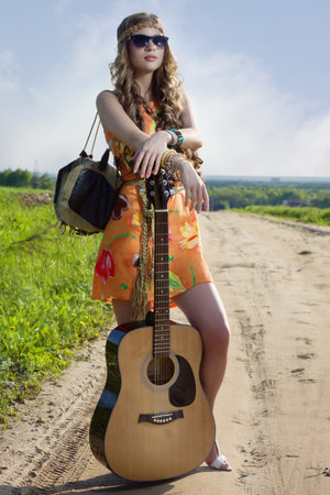 Romantic girl travelling with her guitar. Hippie style.の写真素材